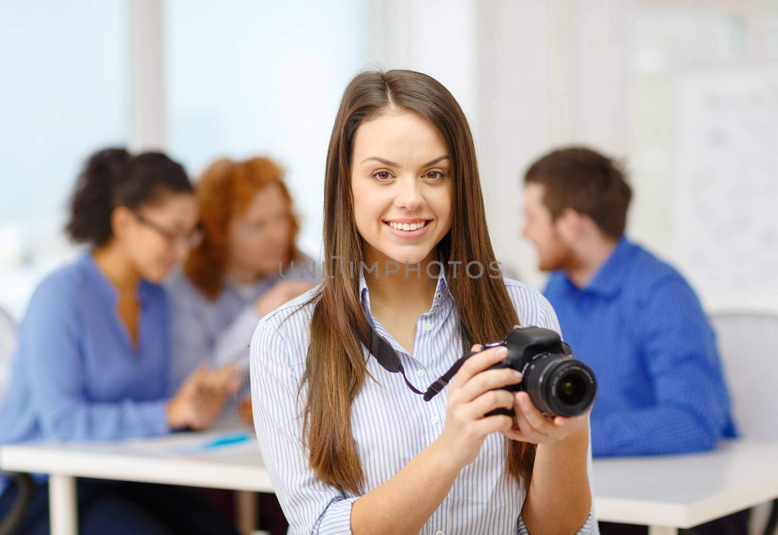 smiling female photographer with photocamera by dolgachov