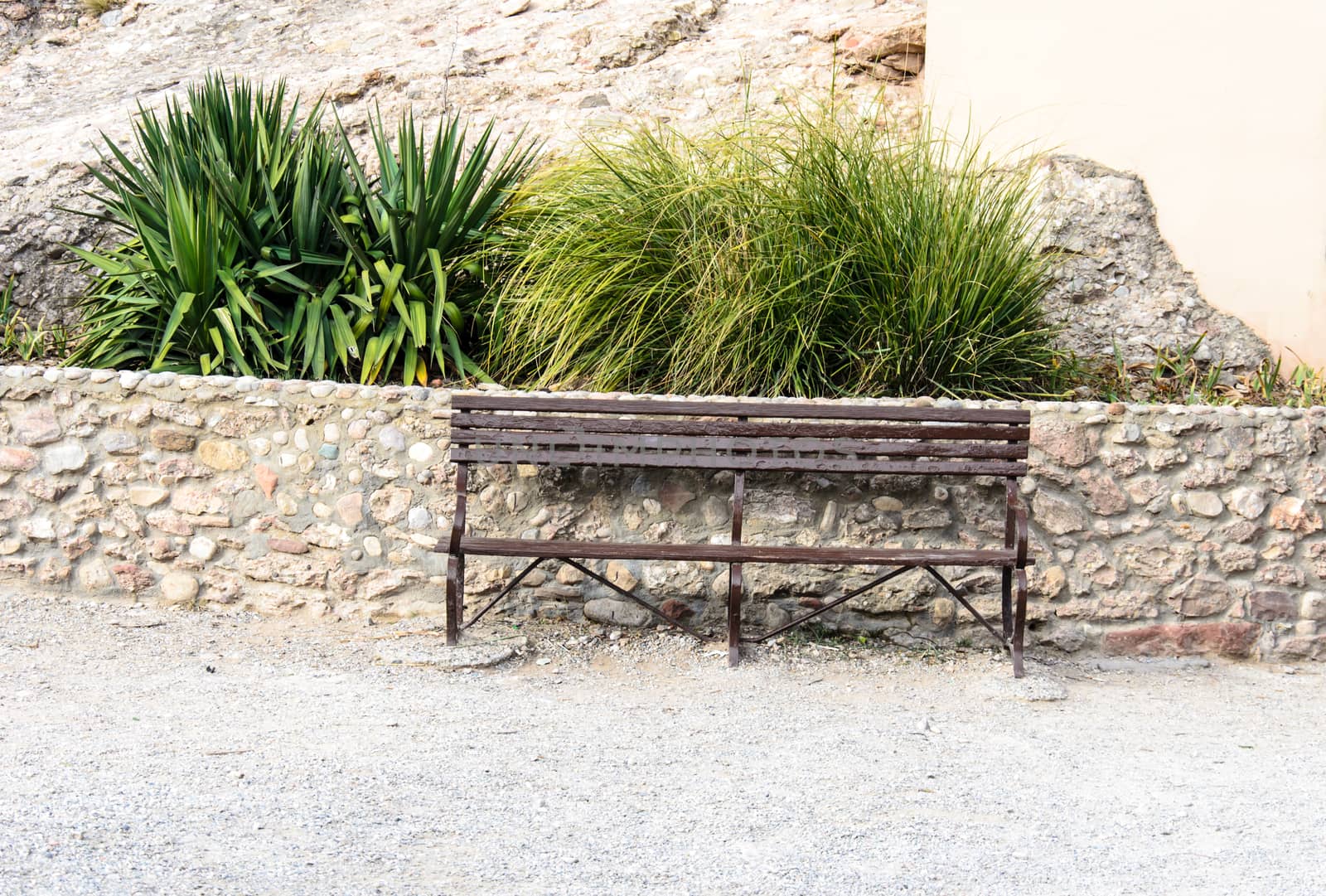 Steel chair in the garden on the sand.