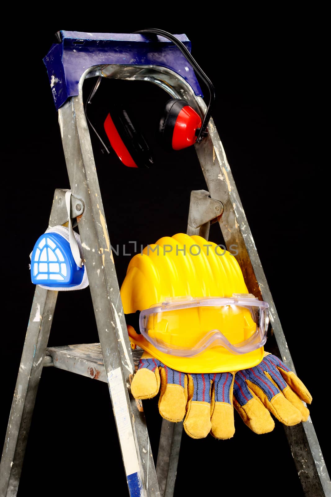 Safety gear kit on step ladder over black 