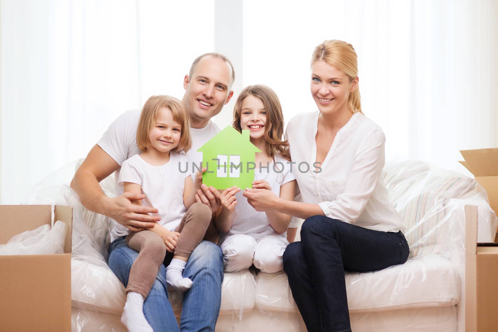 smiling parents and two little girls at new home by dolgachov