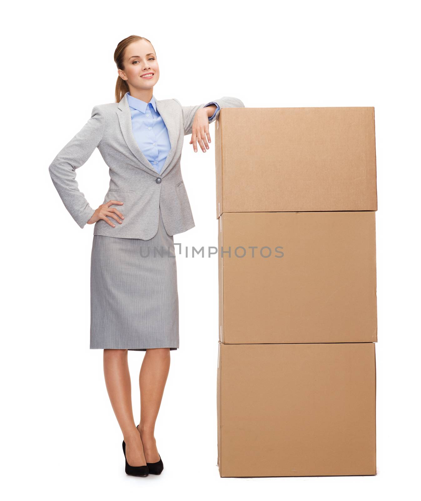 business, post and transportation concept - smiling businesswoman with tower of cardboard boxes