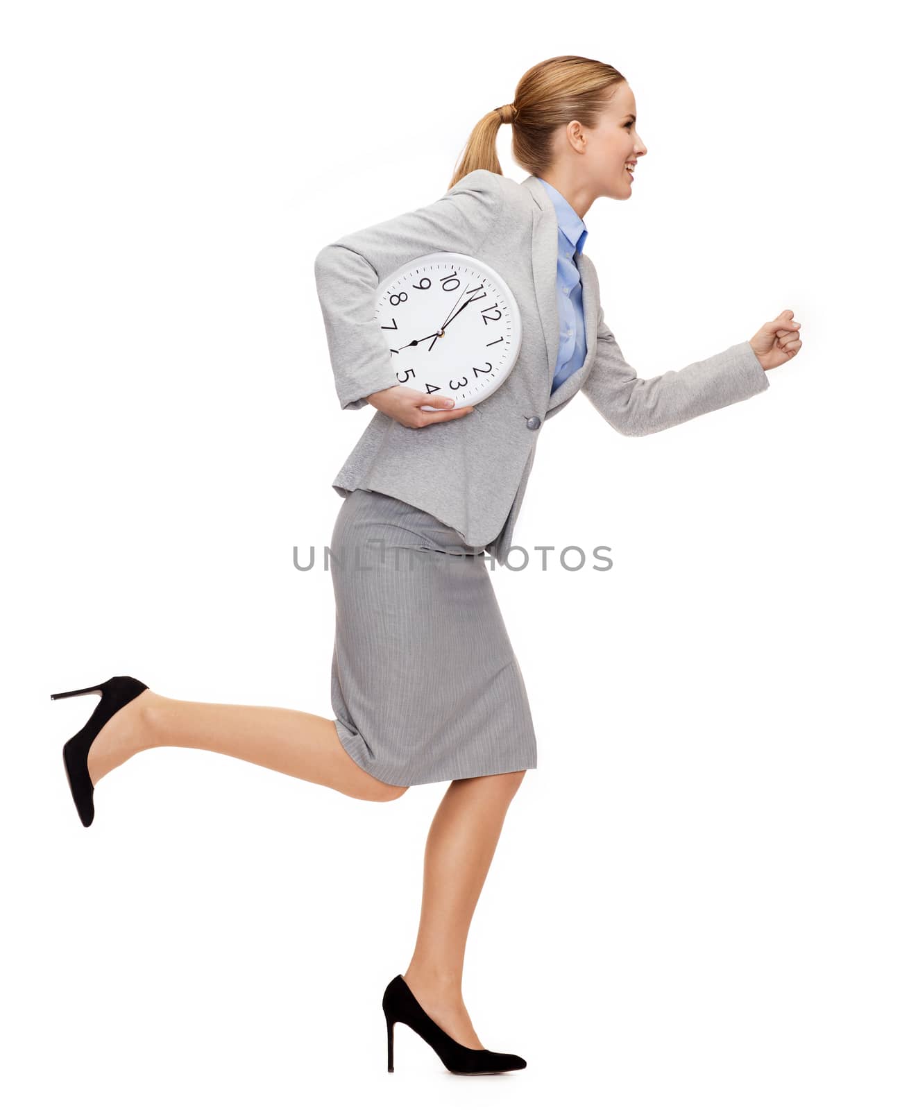 smiling young businesswoman with clock running by dolgachov