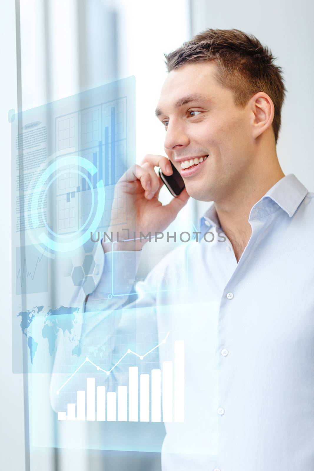smiling businessman with smartphone in office by dolgachov