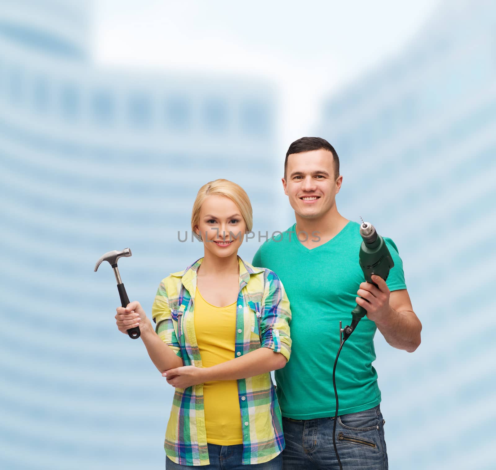 smiling couple with hammer and drill by dolgachov