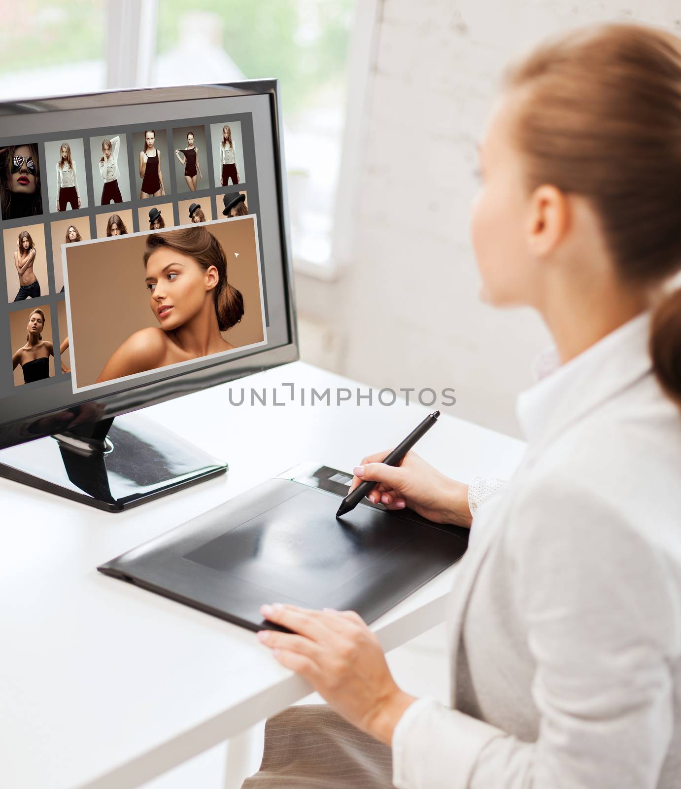 photography, office and magazine concept - female retoucher with drawing tablet and computer working at home or office