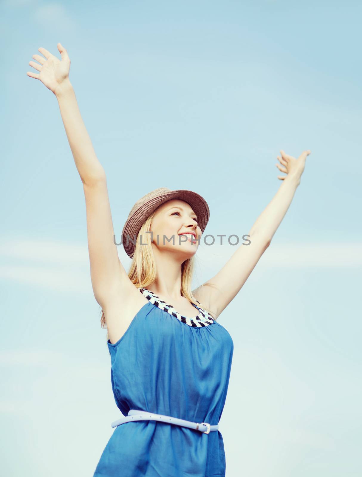 girl with hands up on the beach by dolgachov