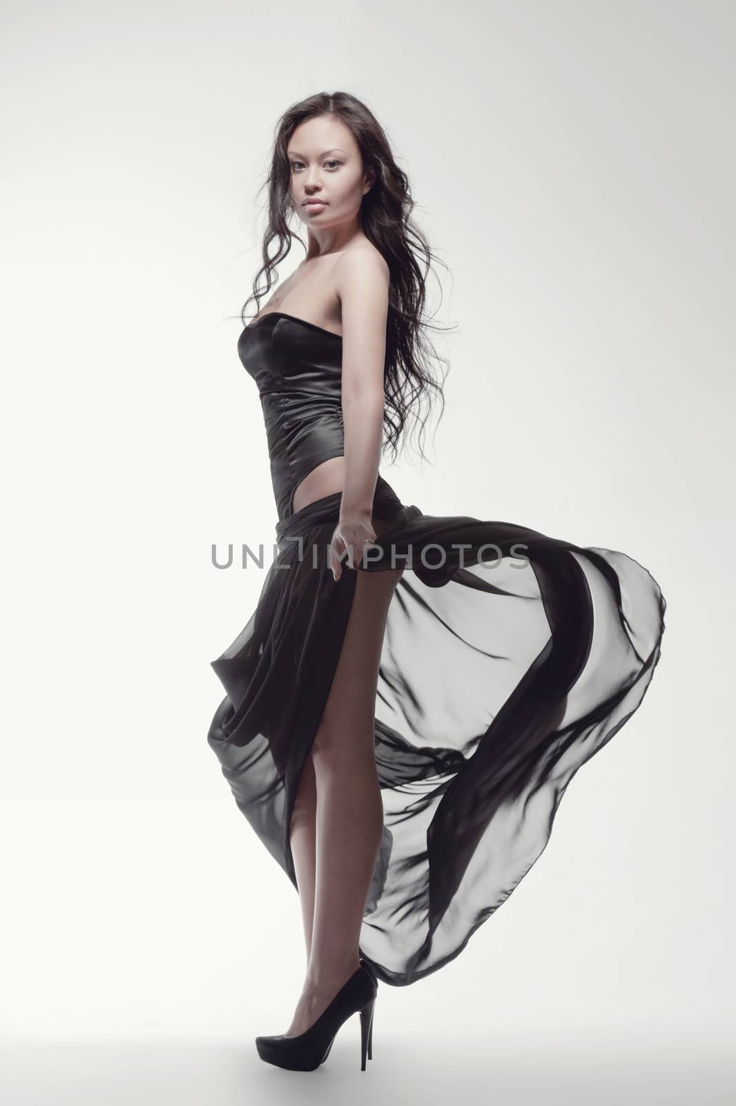 fashion and people concept - gorgeous asian woman in black dress