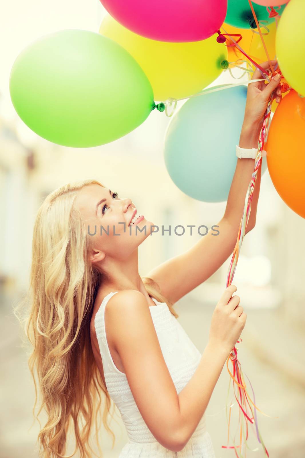 summer holidays, celebration and lifestyle concept - beautiful woman with colorful balloons in the city