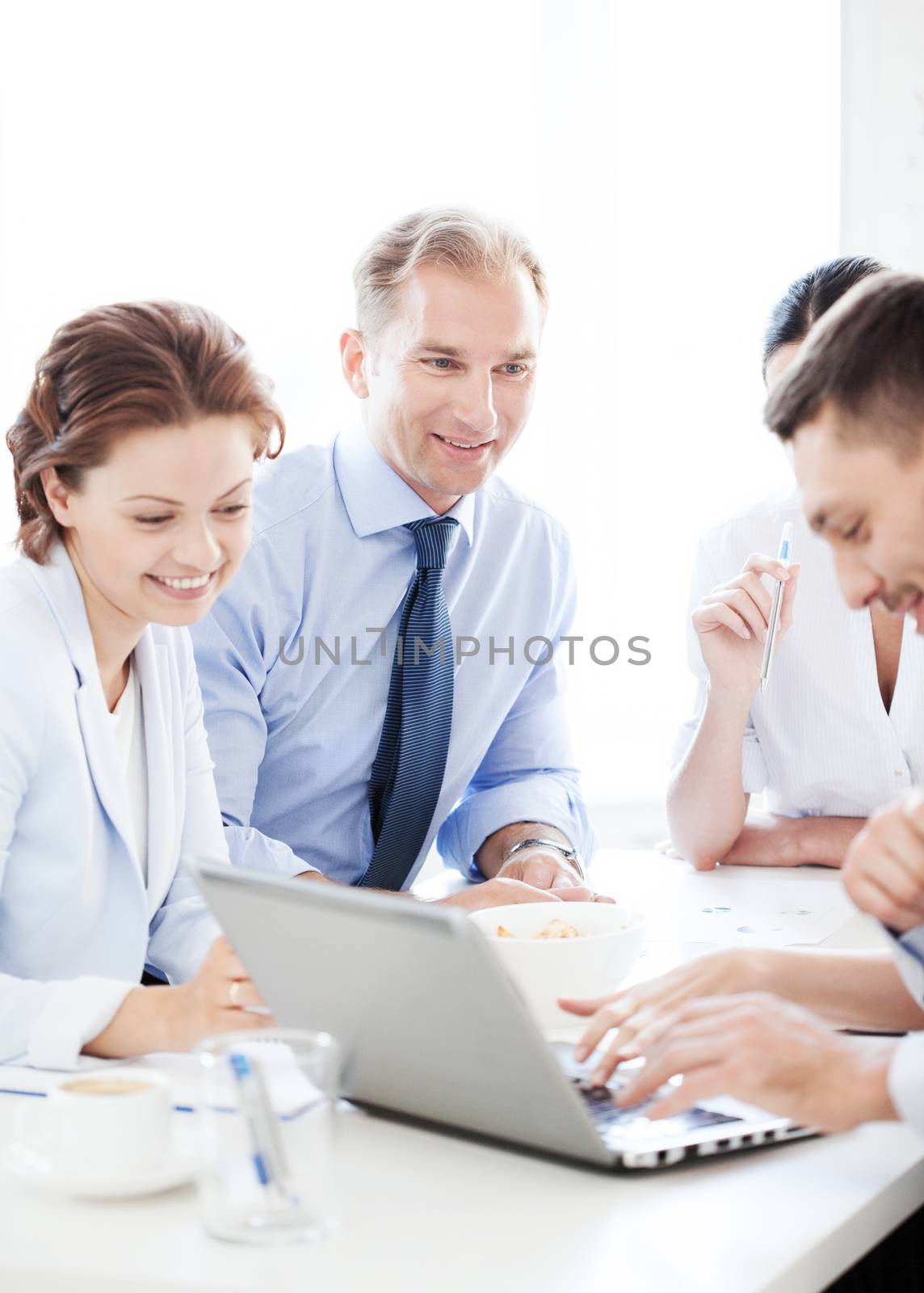 business concept - smiling businessman with team on meeting in office