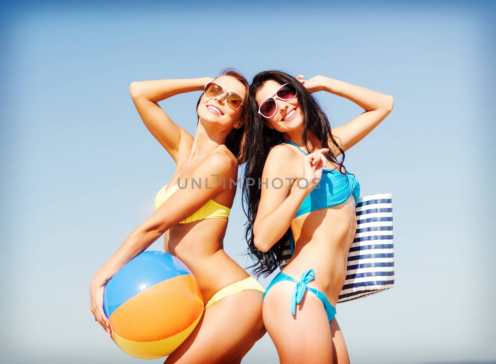 summer holidays, vacation and beach activities - girls with ball on the beach