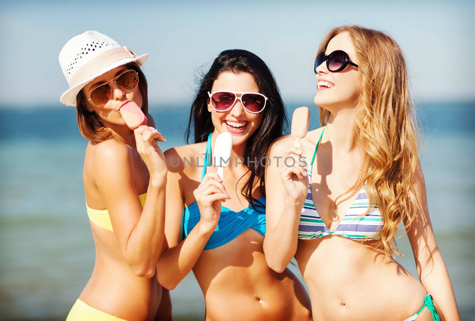 girls in bikini with ice cream on the beach by dolgachov