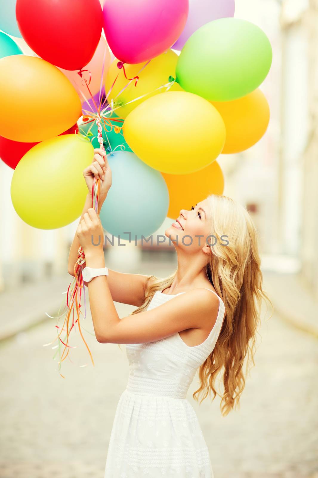 summer holidays, celebration and lifestyle concept - beautiful woman with colorful balloons in the city