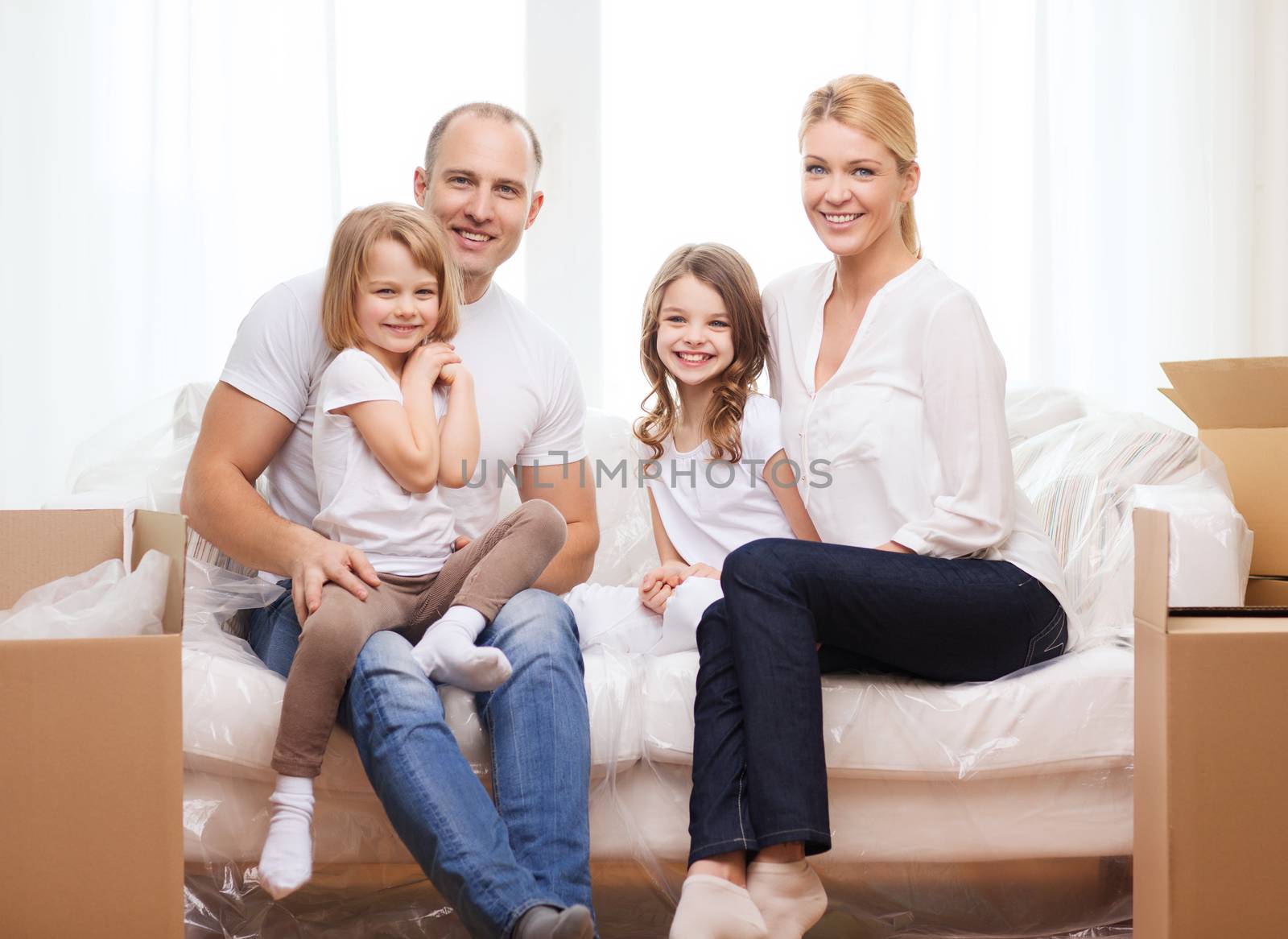 smiling parents and two little girls at new home by dolgachov