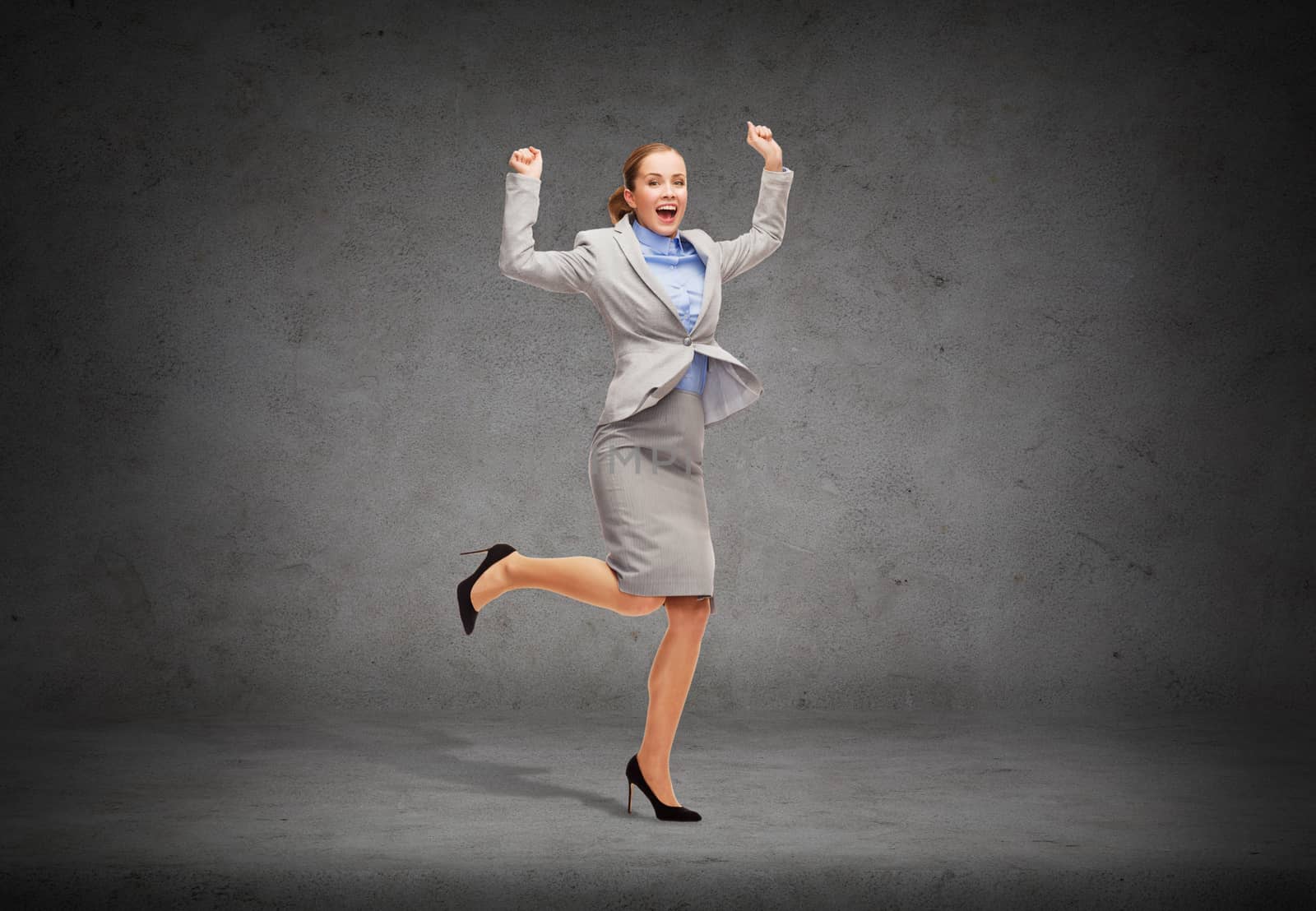 business and education concept - young happy woman jumping with hands up