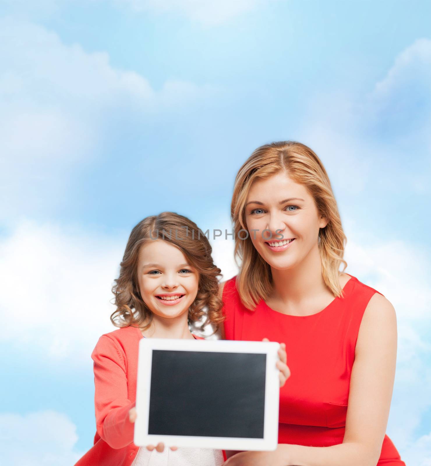smiling mother and daughter with tablet pc by dolgachov