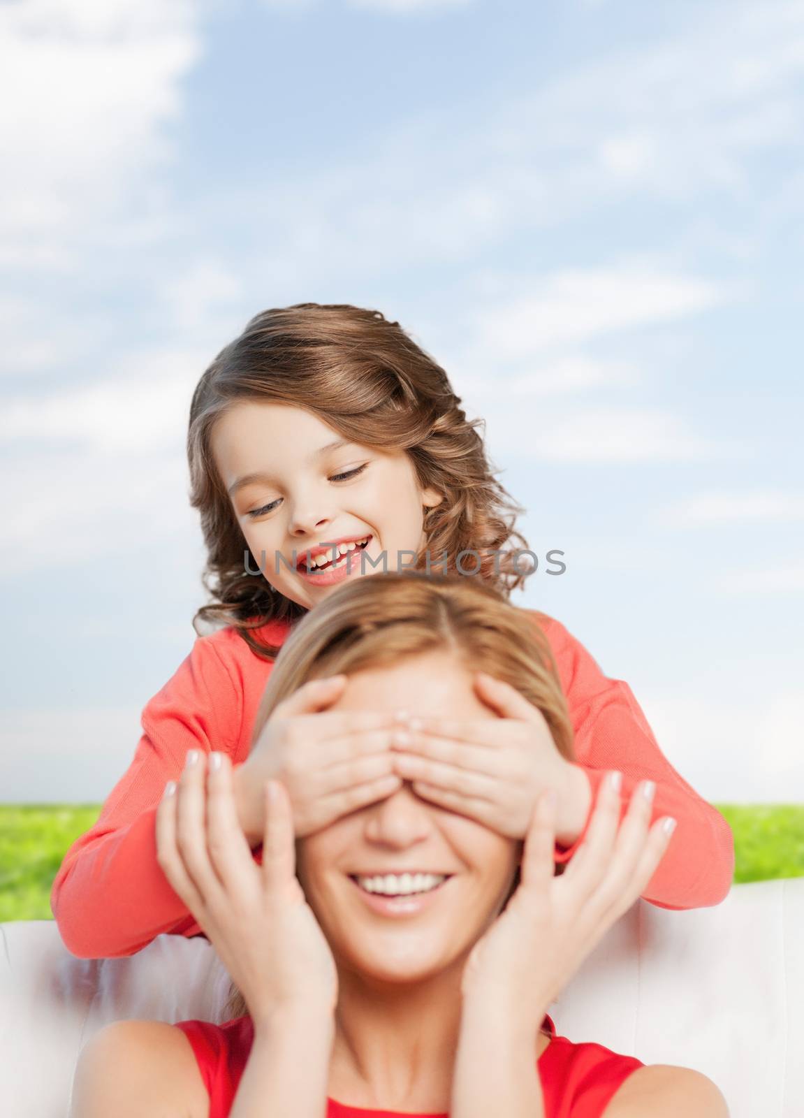 family, child and happiness concept - smiling mother and daughter making a joke