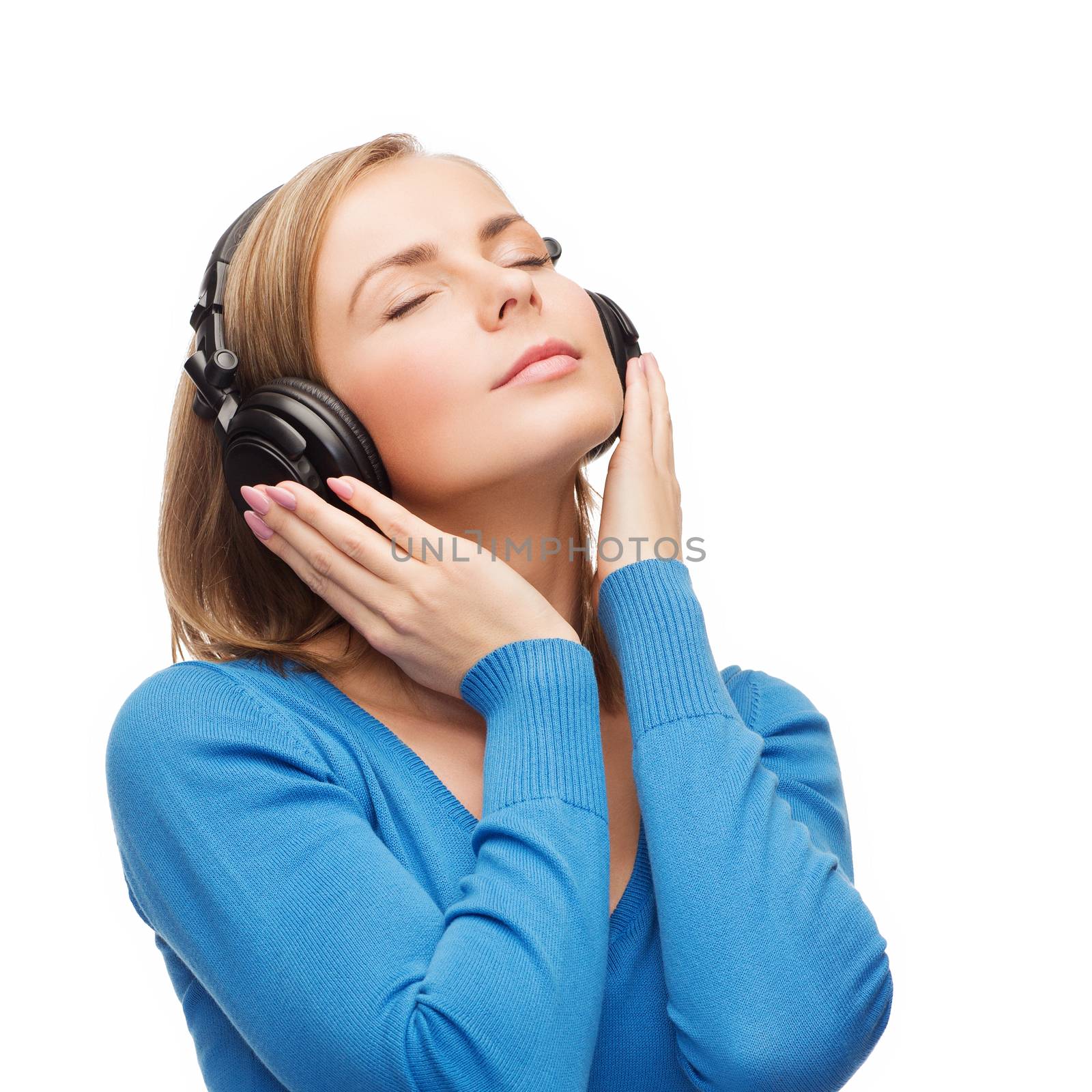 music and technology concept - calm young woman with closed eyes listeting to music with headphones