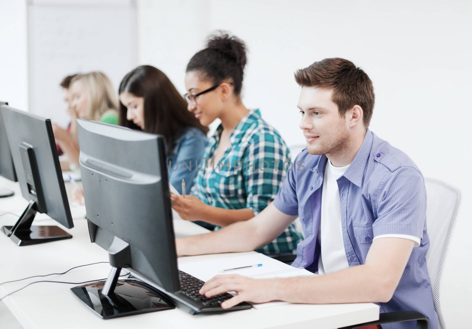 student with computer studying at school by dolgachov