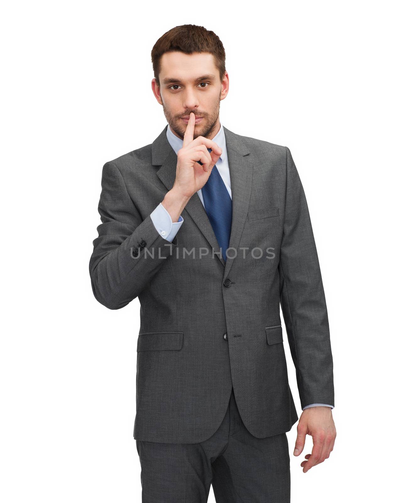 business, education and office concept - handsome businessman with finger on his lips