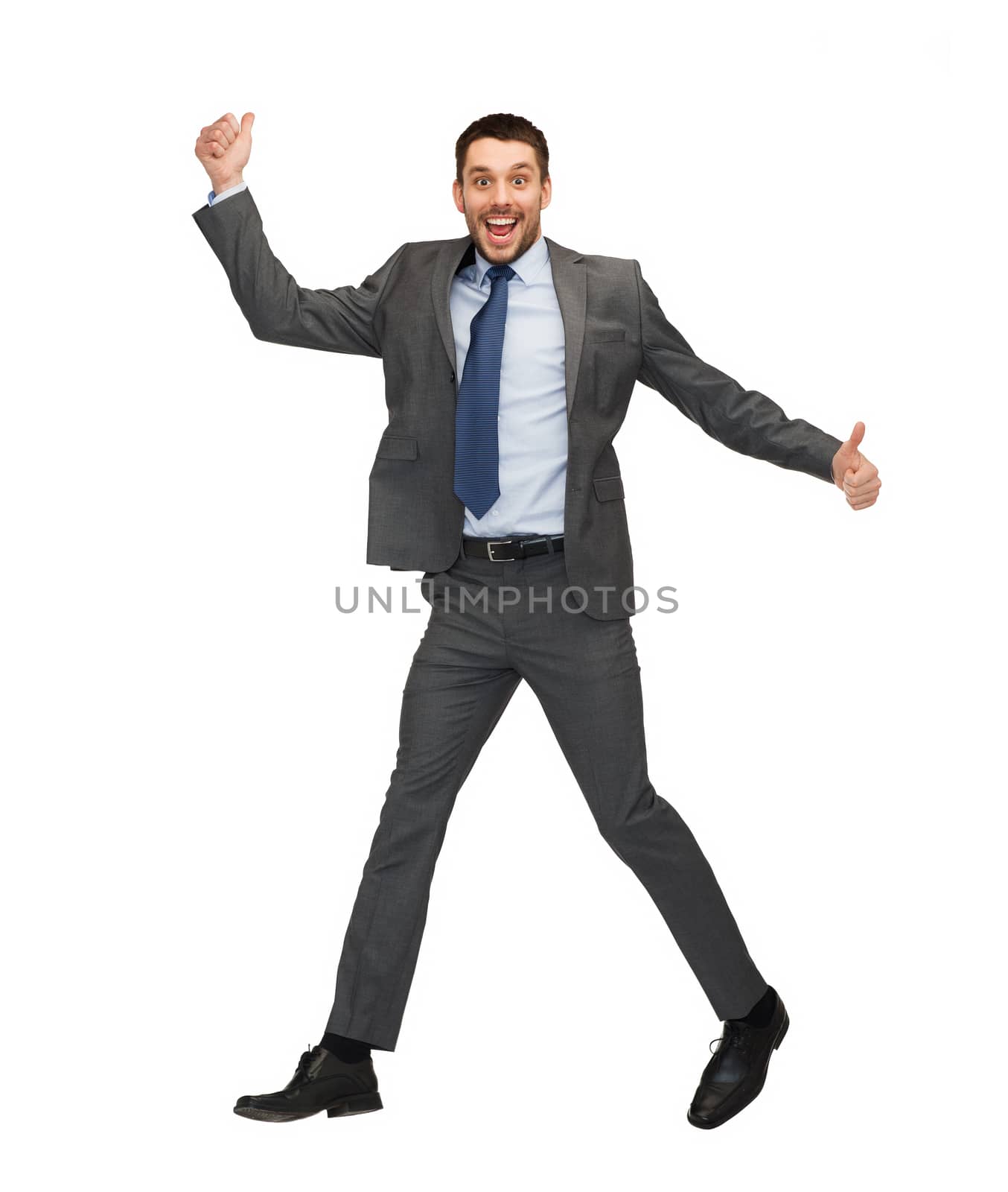 smiling businessman jumping and showing thumbs up by dolgachov