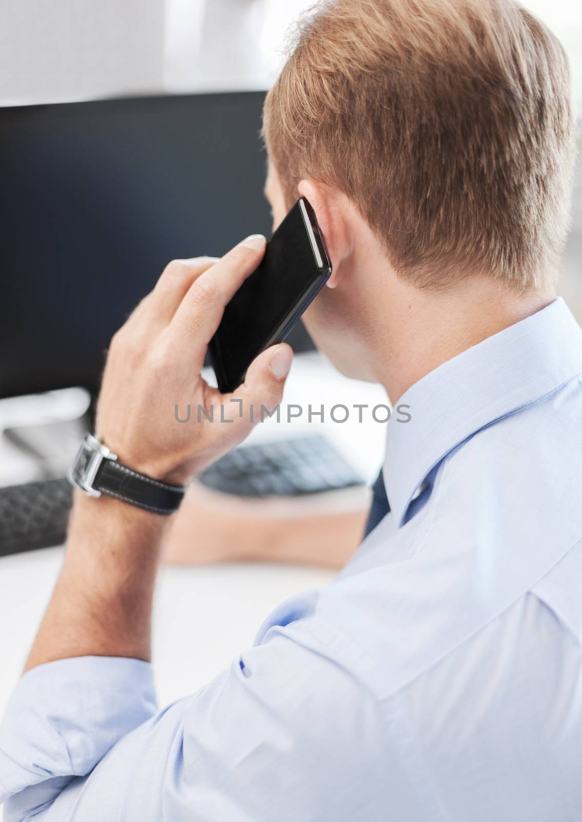 business, communication and technology concept- businessman with smartphone in office