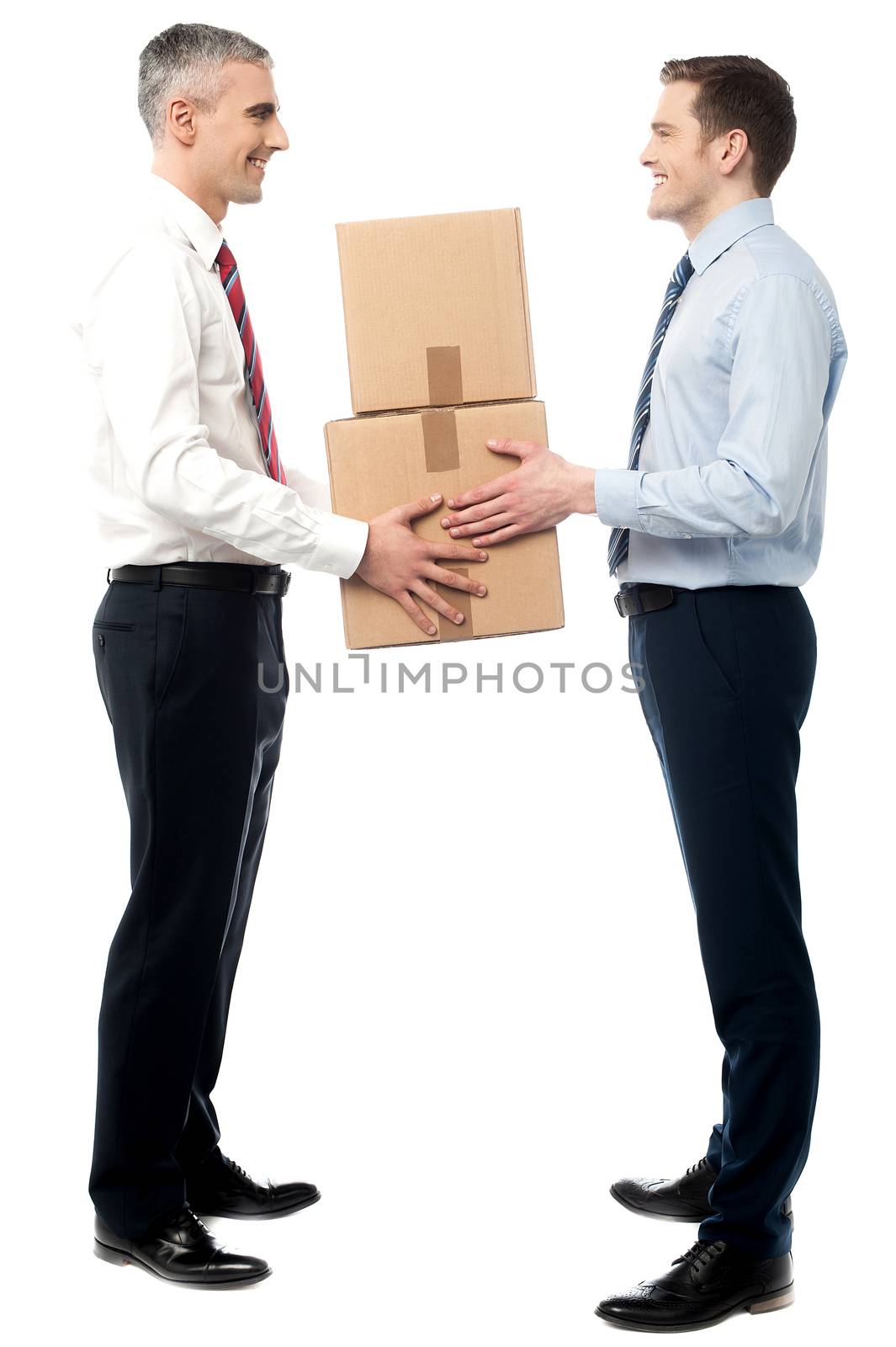 Smiling young men receive cartons boxes by stockyimages