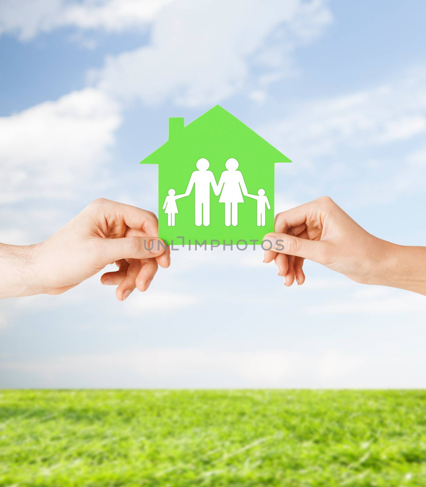 hands holding green house with family by dolgachov