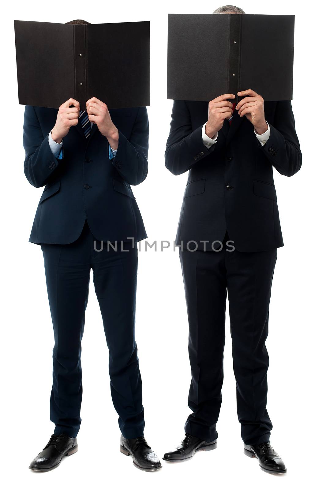 Businessmen hiding their faces with folder by stockyimages