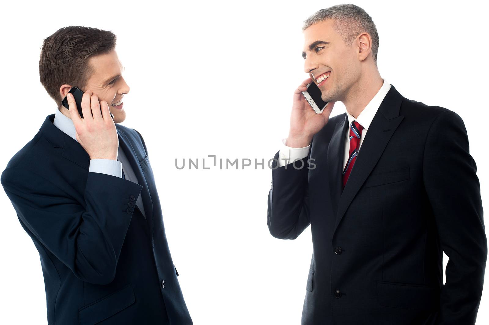 Handsome businessmen with cell phones by stockyimages