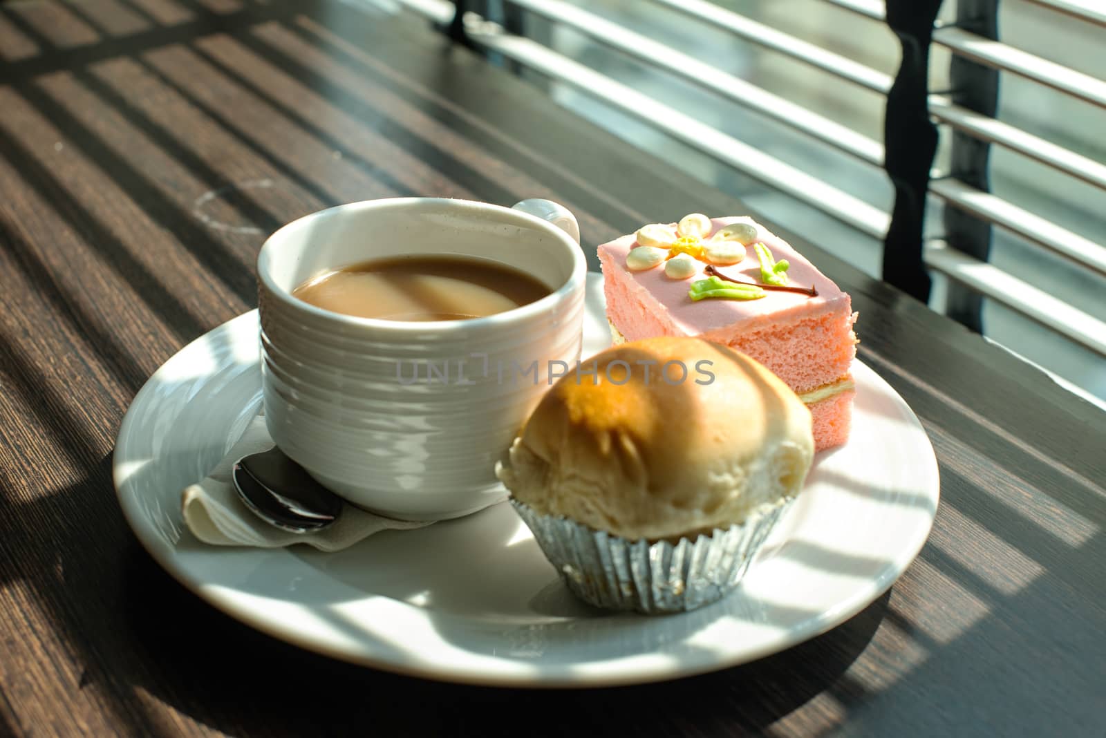 Hot coffee in white cup with sandwich ham&cheese and sweetmeat