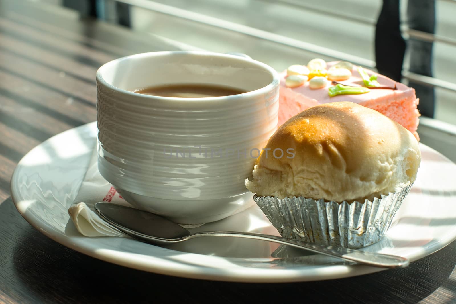 Hot coffee in white cup with sandwich ham&cheese and sweetmeat