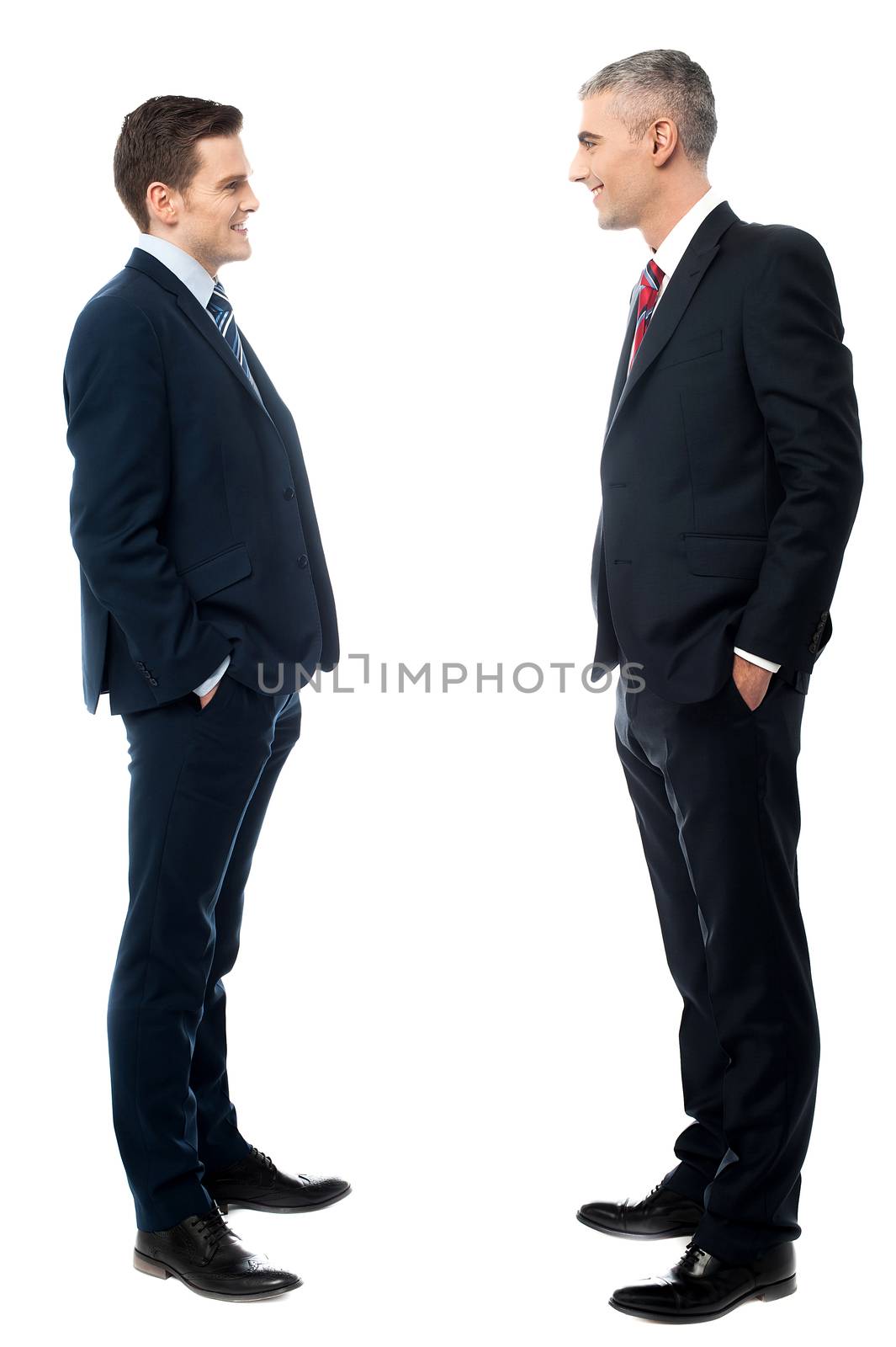 Businessmen conversation together, hands in pockets