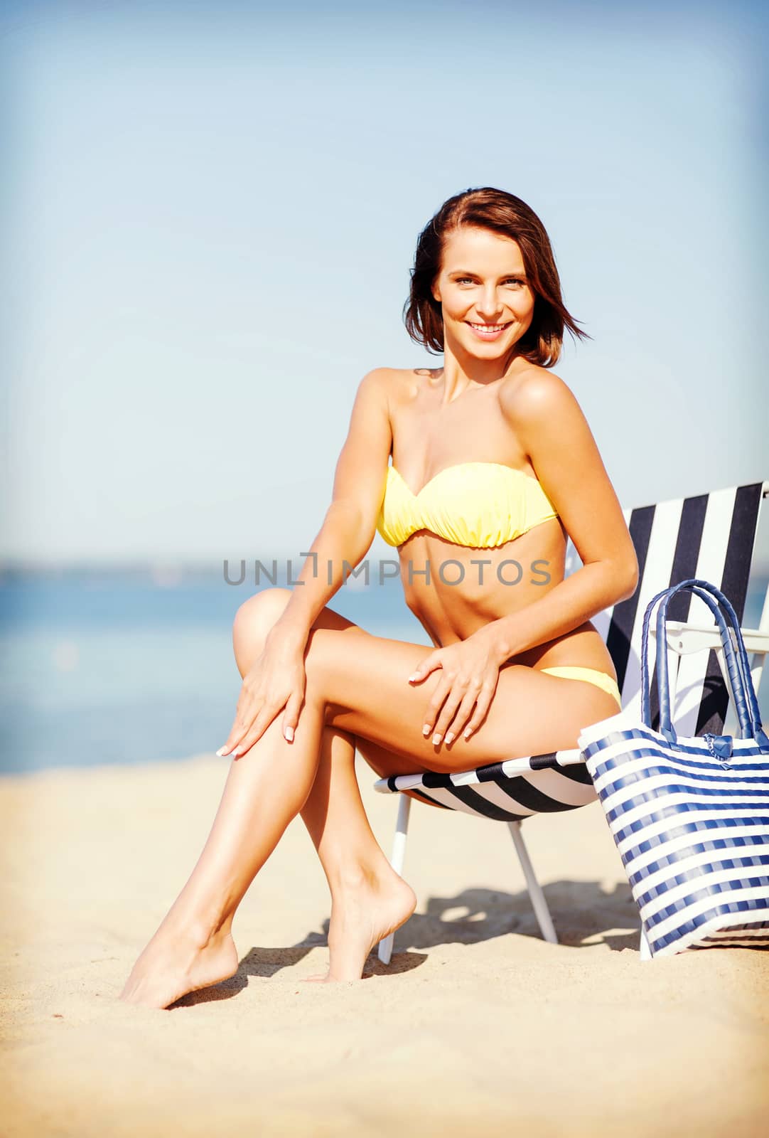 summer holidays and vacation - girl sunbathing on the beach chair