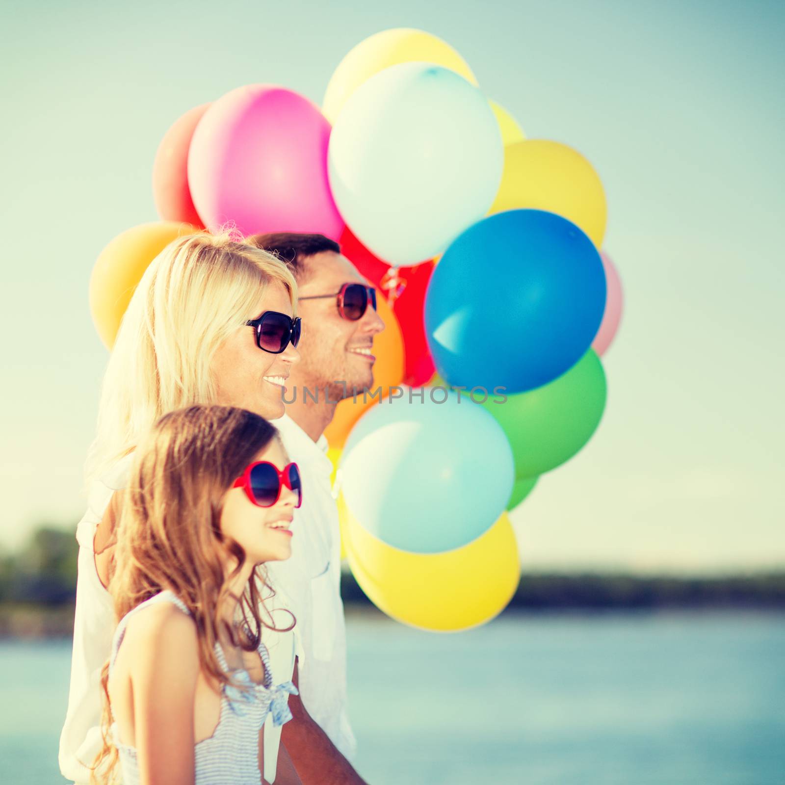 summer holidays, celebration, children and people concept - family with colorful balloons