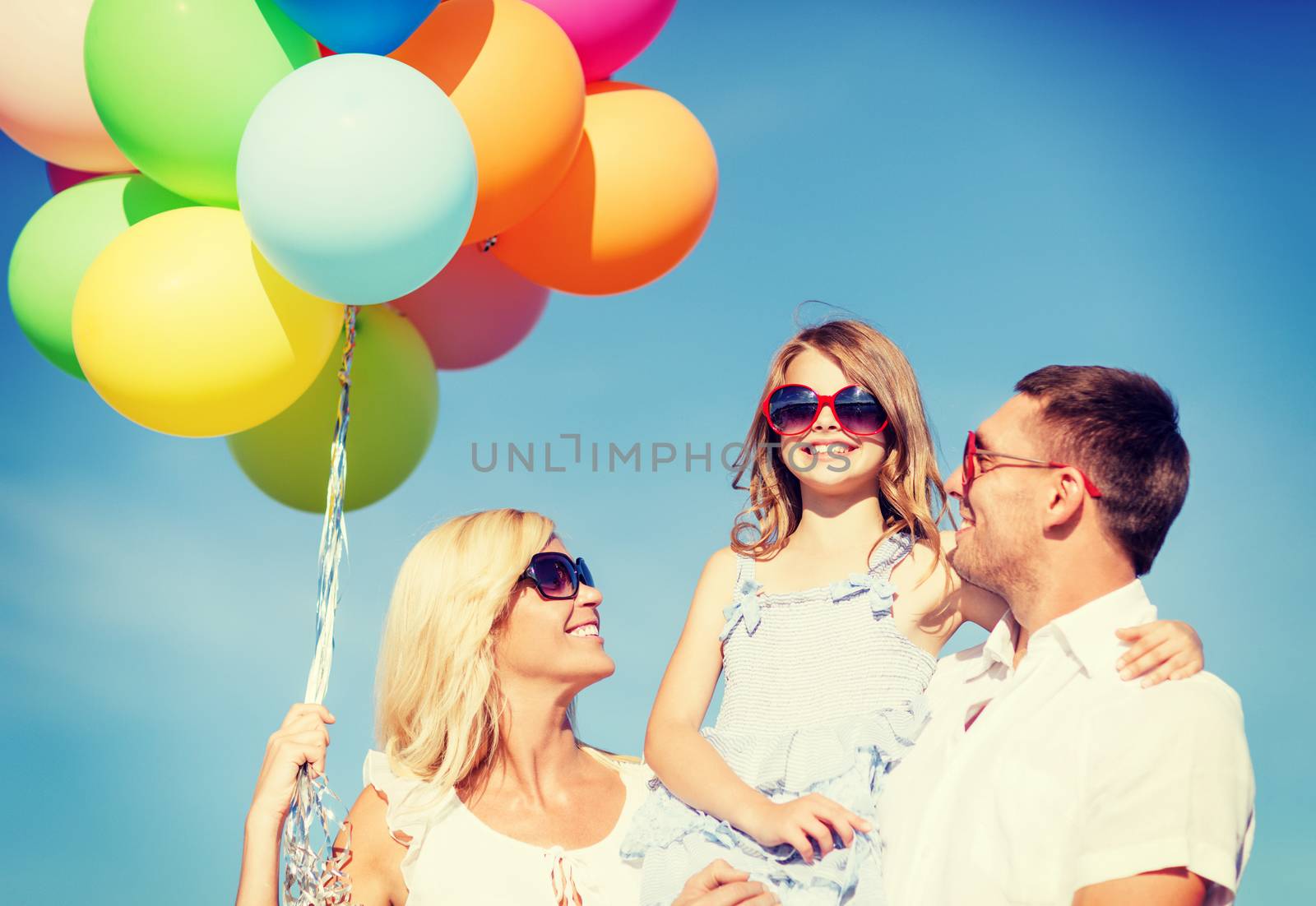 family with colorful balloons by dolgachov