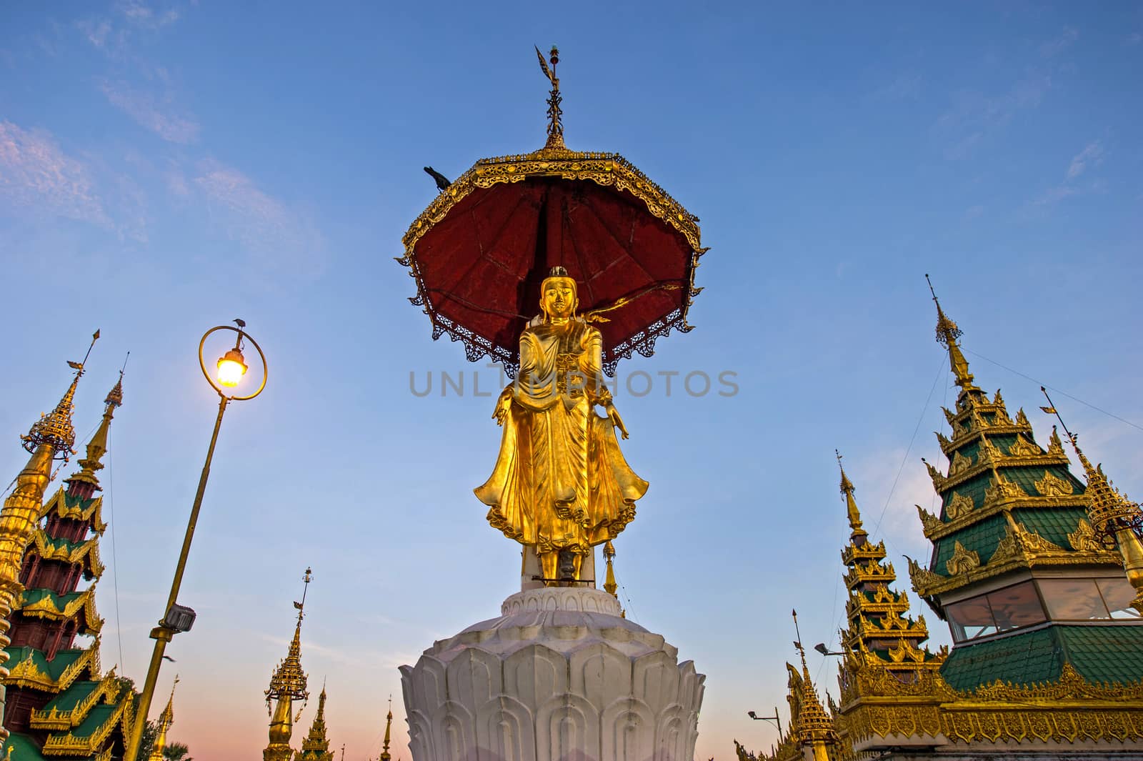 Buddha statue on top of pagoda around Shwedagon Pagoda - Yangon, by think4photop