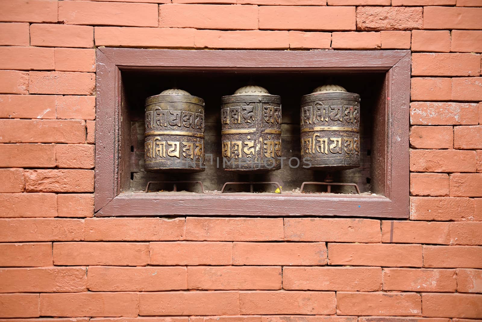 prayer wheels in the beautiful golden temple in patan, nepal by think4photop