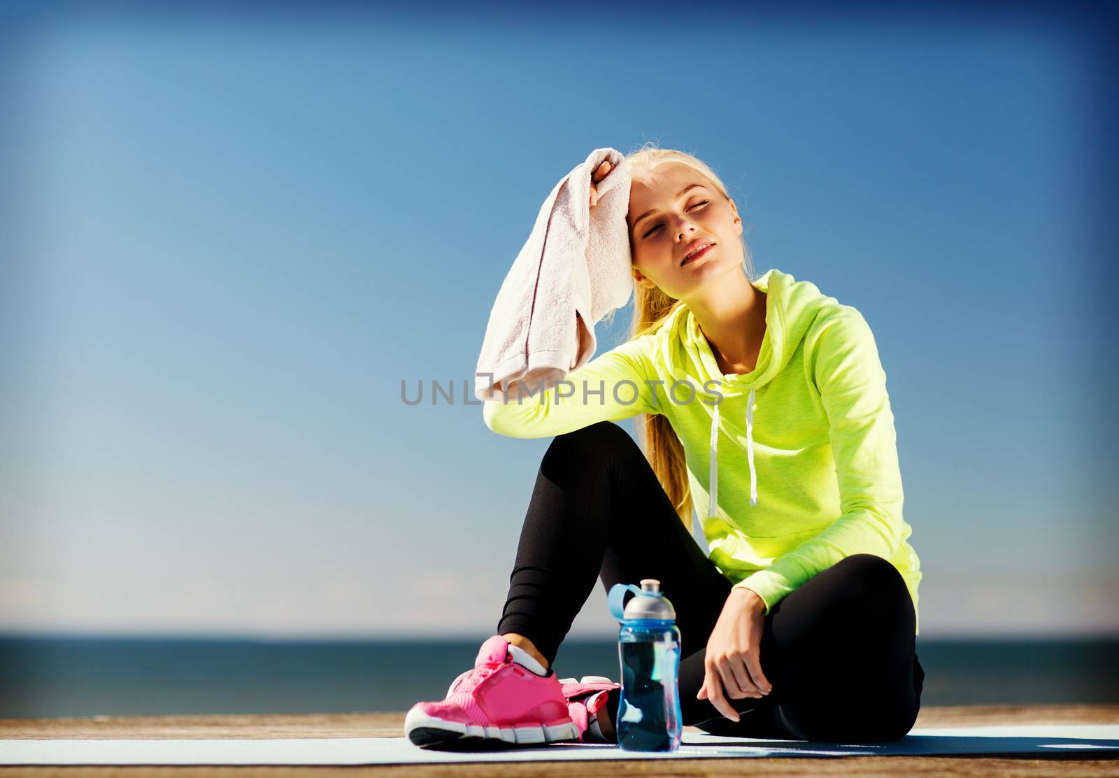 woman resting after doing sports outdoors by dolgachov