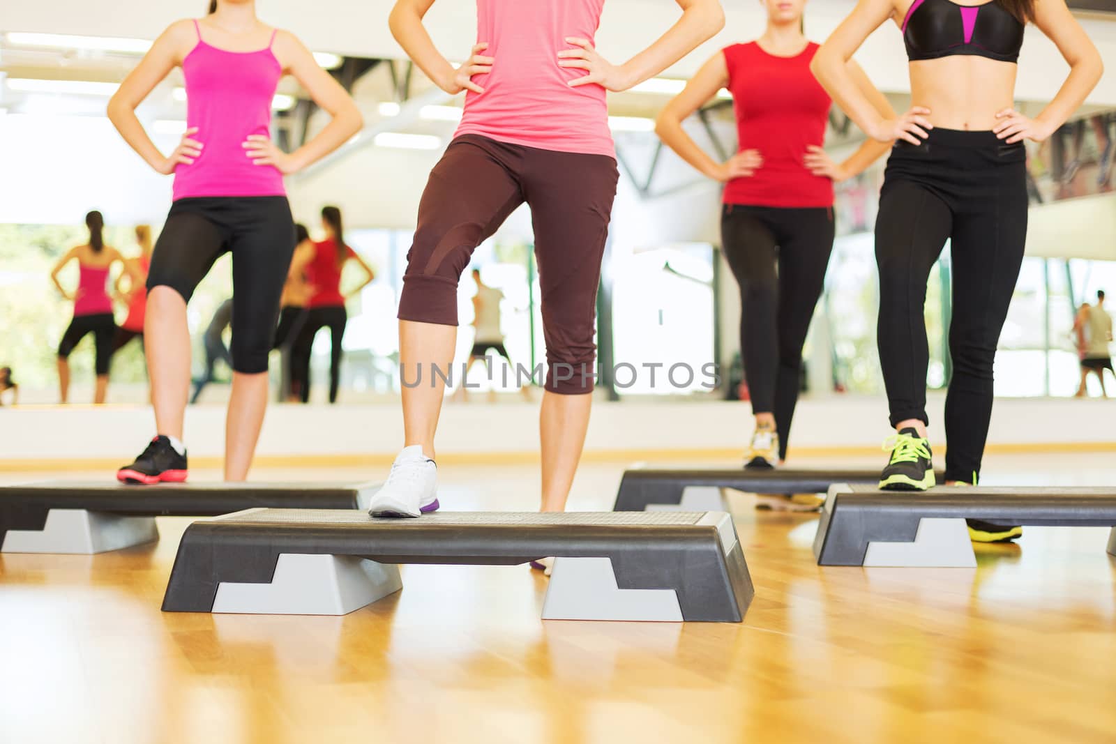 fitness, sport, training, gym and lifestyle concept - close up of women legs steping on step platform in gym