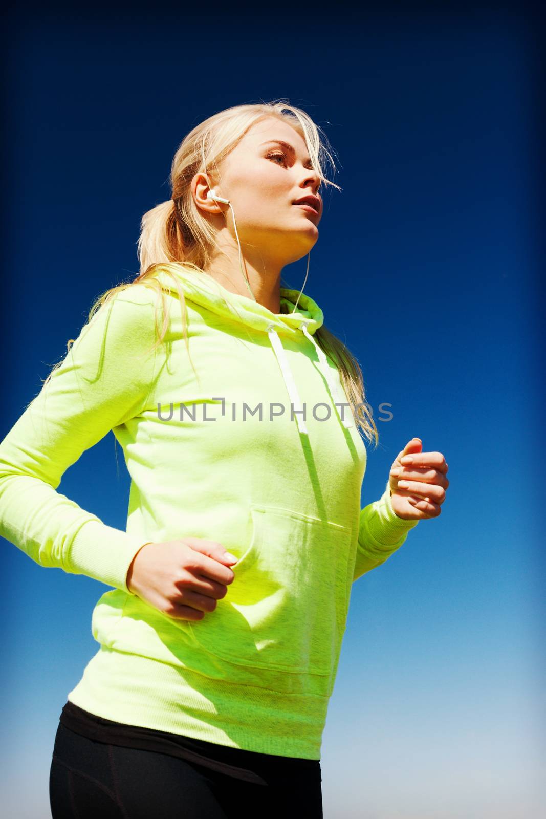 woman doing running outdoors by dolgachov
