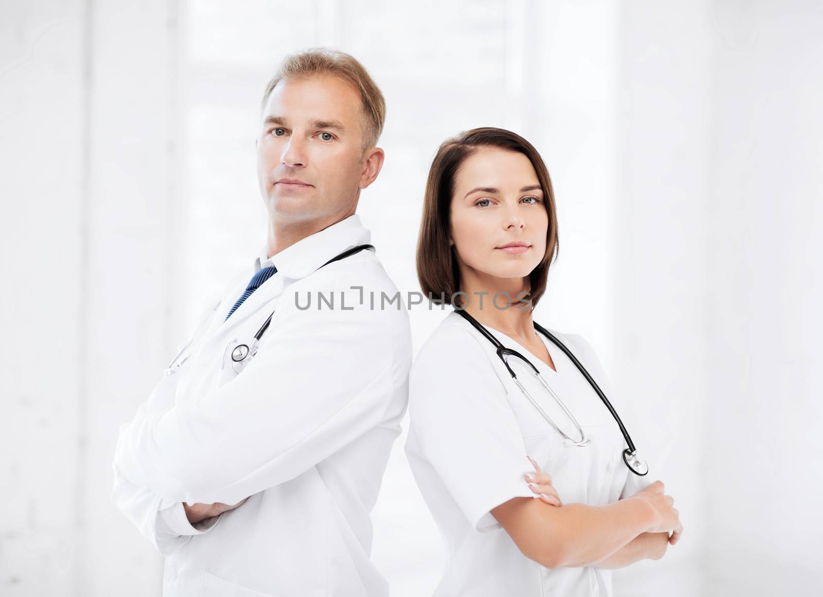 two doctors with stethoscopes by dolgachov