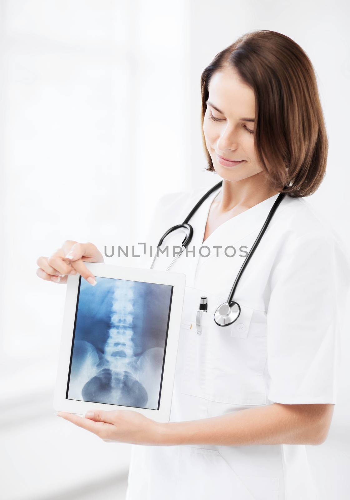 female doctor with x-ray on tablet pc by dolgachov
