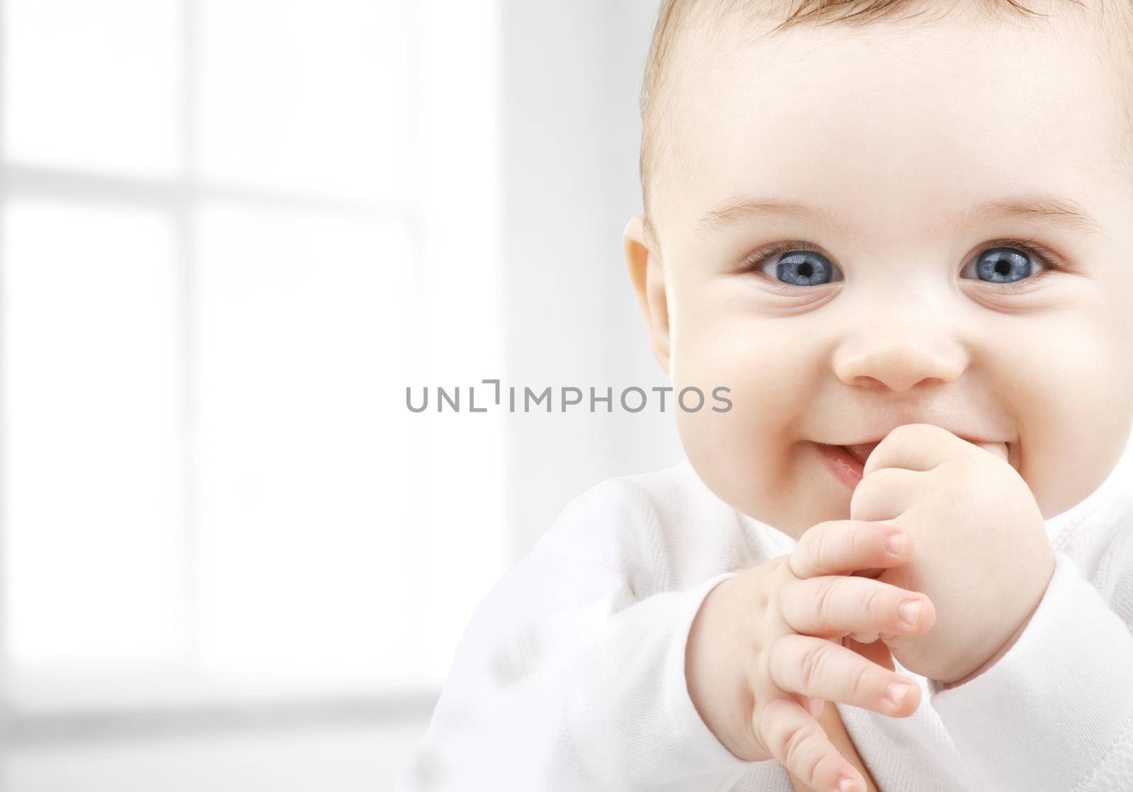 child, happiness and people concept - adorable baby