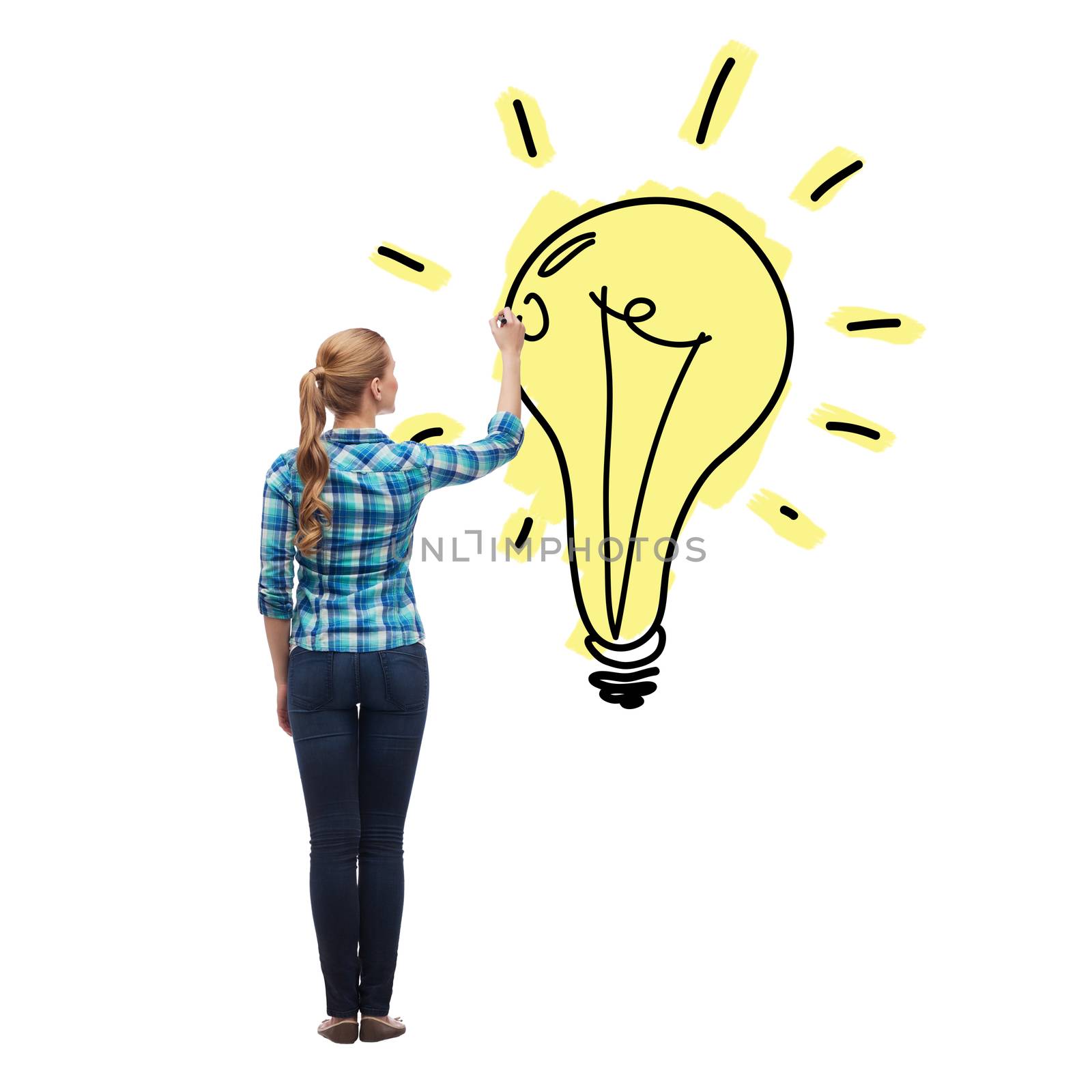 education and advertising concept - young woman from the back drawing light bulb in the air