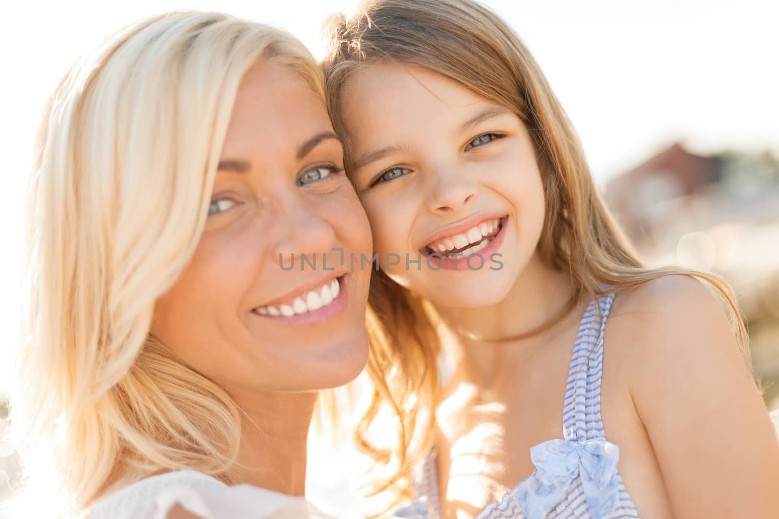 happy mother and child girl outdoors by dolgachov