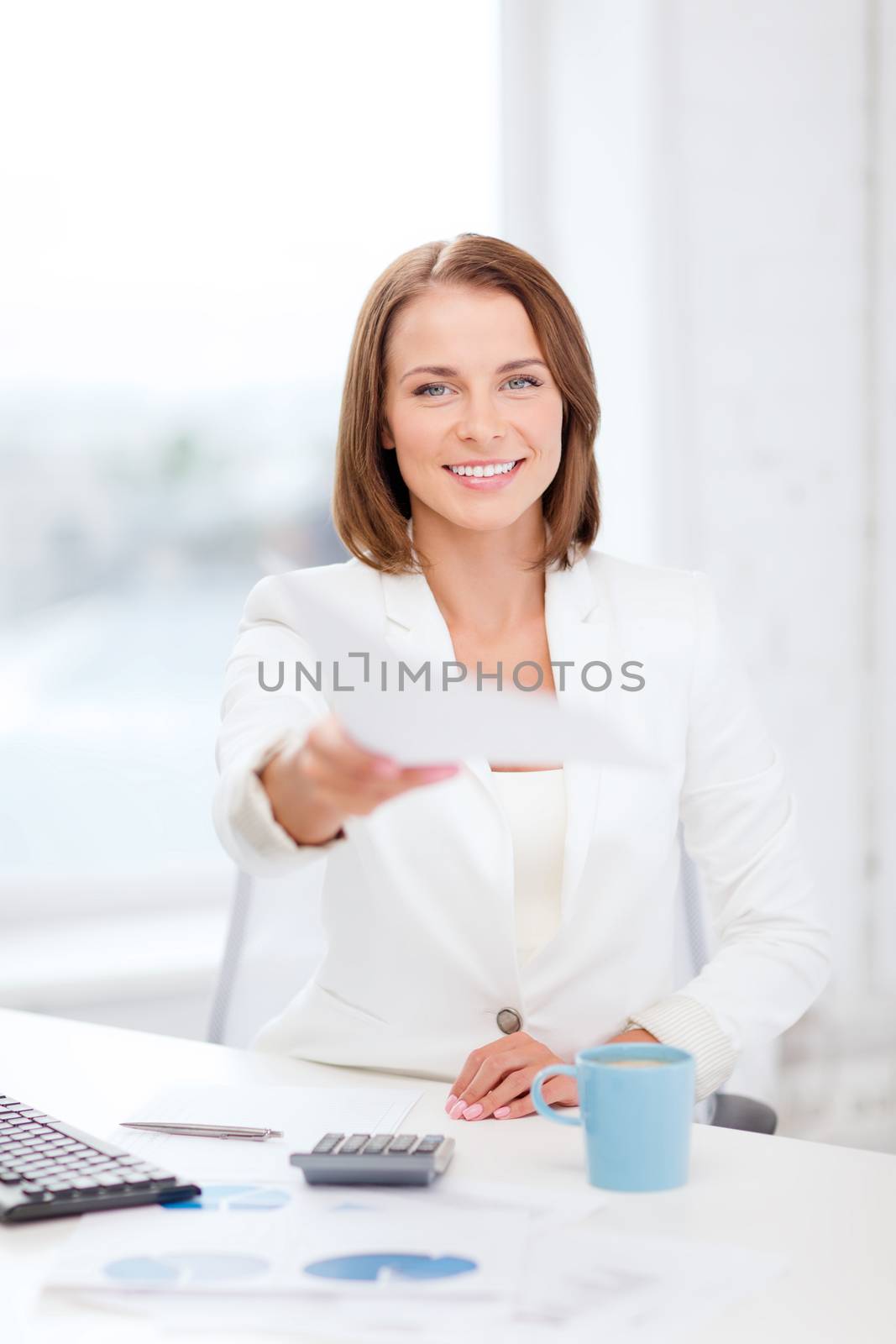 sming businesswoman giving papers in office by dolgachov