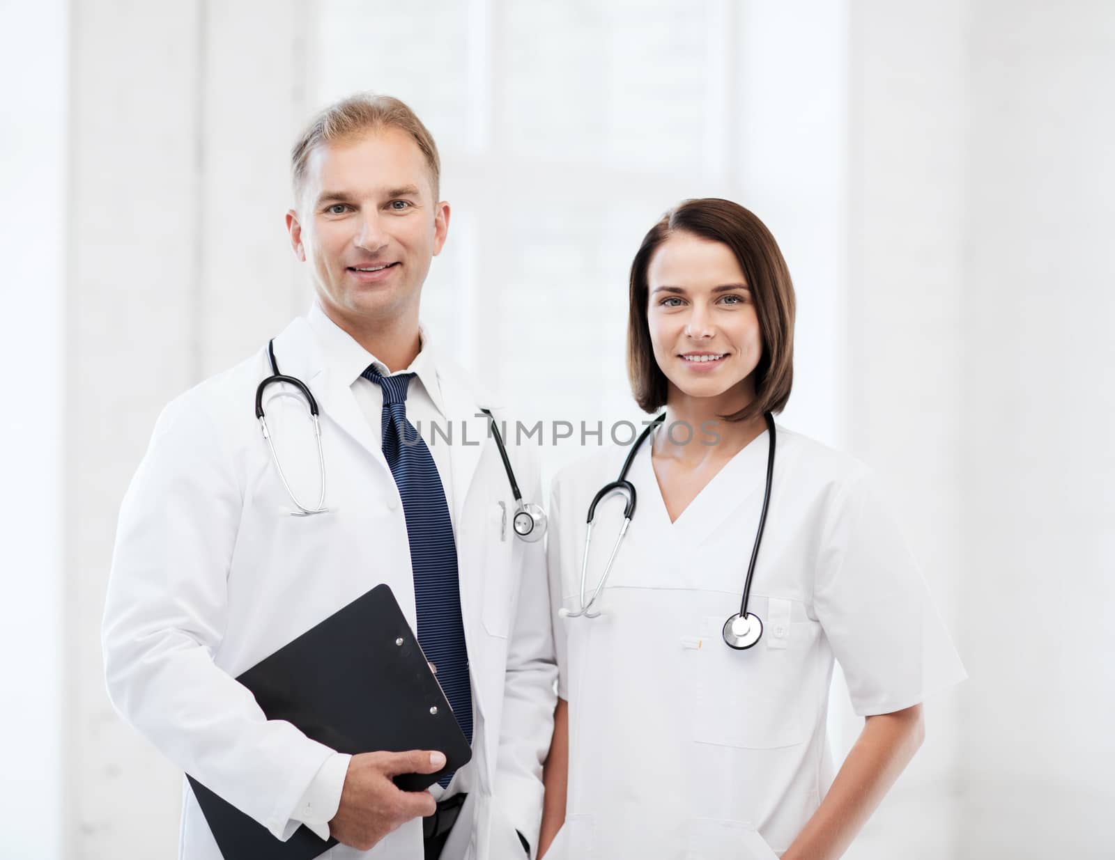 two doctors with stethoscopes by dolgachov