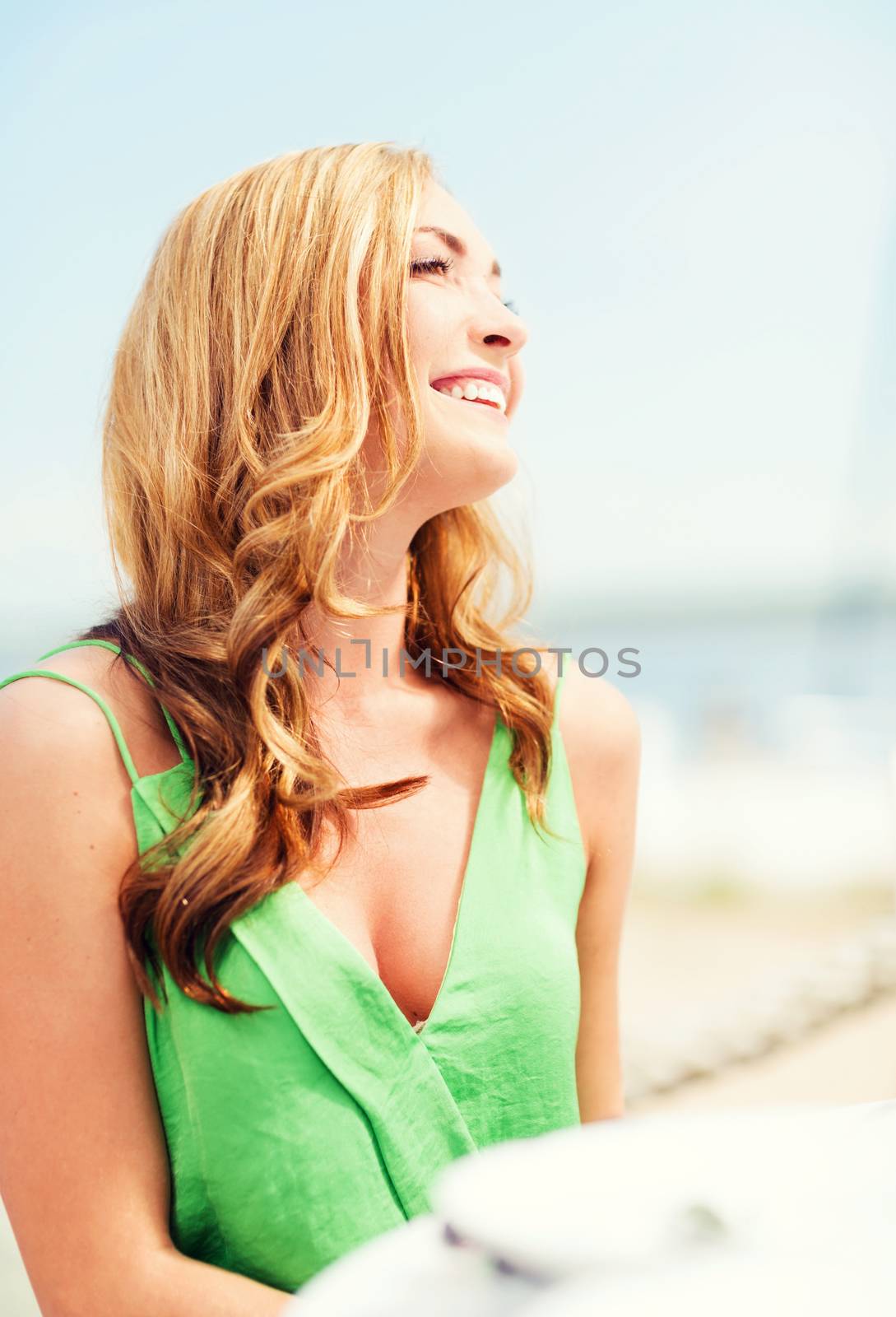 summer holidays and vacation - girl in cafe on the beach