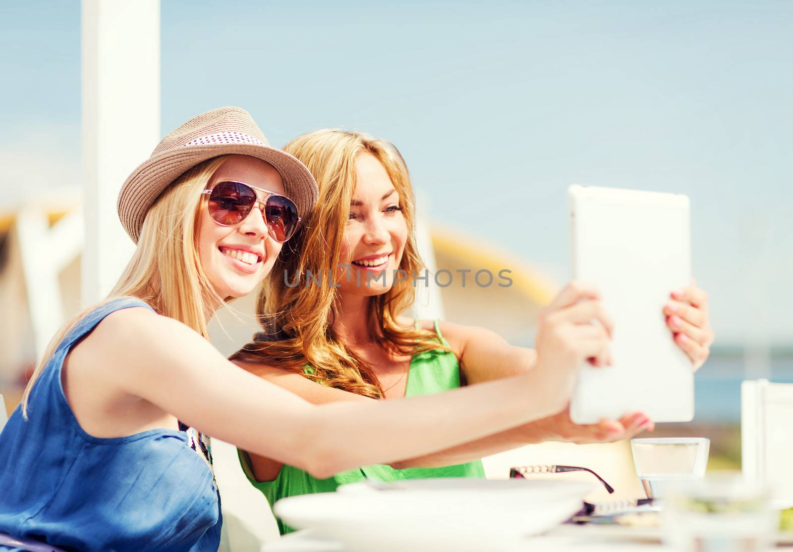 girls taking photo in cafe on the beach by dolgachov