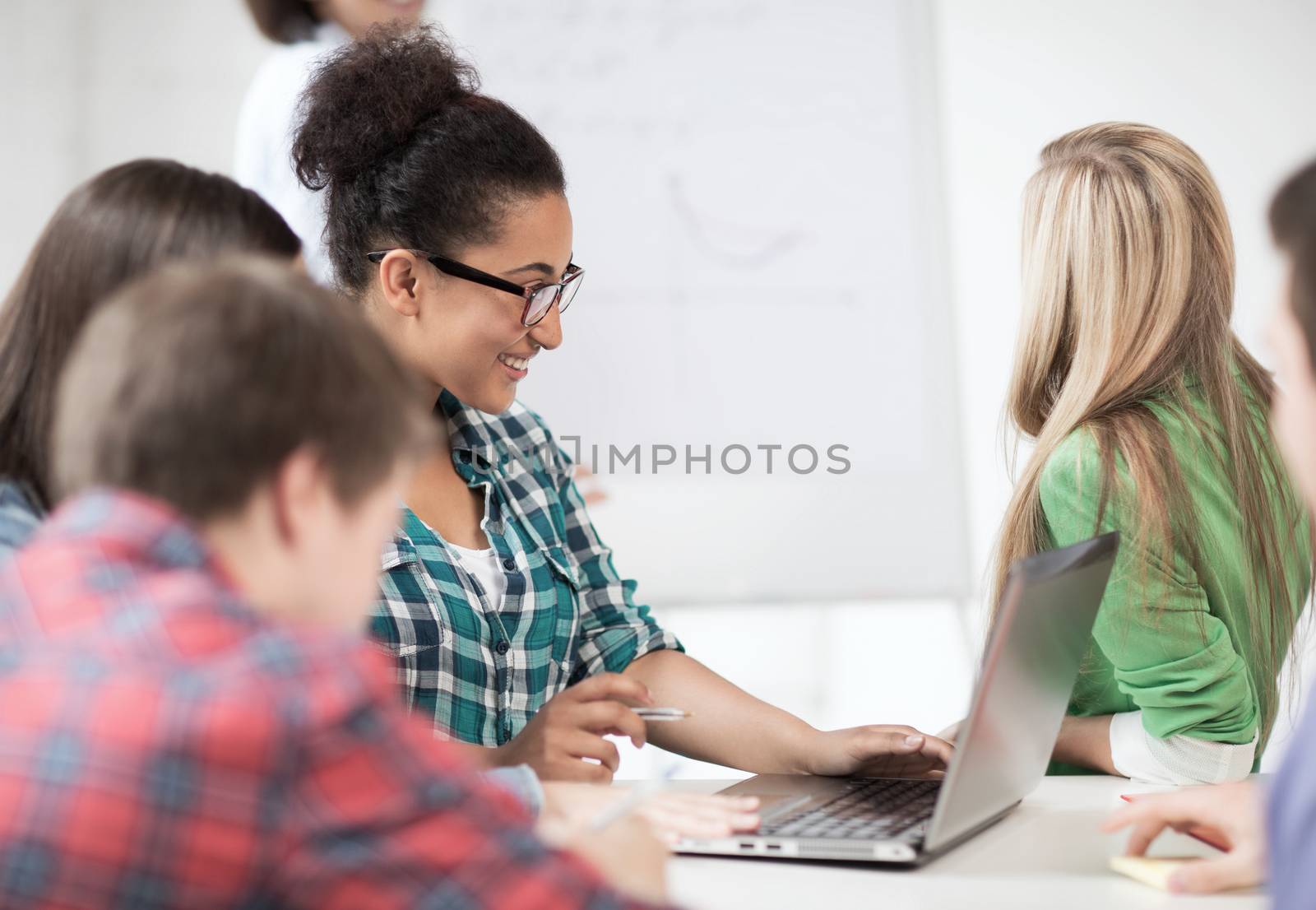 education and internet - african student girl with laptop at school